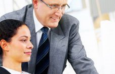 Professor standing over student's shoulder