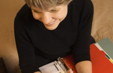 Woman smiling with binder in hand