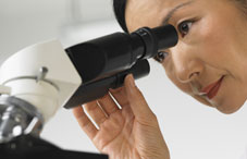 Woman looking through microscope