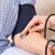 Health care provider checking woman's blood pressure  