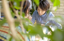 Women behind plants looking down 