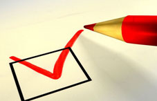 Red ink pen checking a paper box