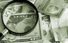 Magnifying glass laying on money