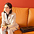 Woman sitting on orange couch