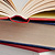Open book on top of other books