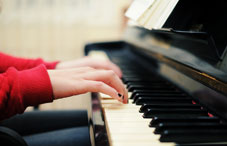 Closeup of hands playing a piano