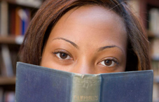 Book covering half a woman's face