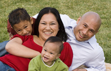 Happy family laying on grass