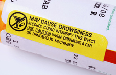 Caution sticker on a pill bottle