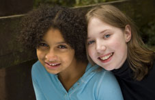 Two girls from different nationalities smiling