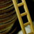 Ladder tilted against stack of quarters 