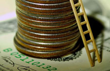 Ladder tilted against stack of quarters 