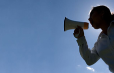Person yelling through electronic megaphone