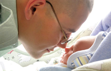 Boy and baby noses touching