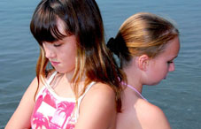 Two girls standing back-to-back