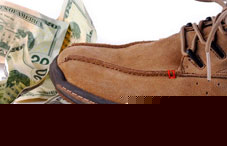 Shoe beside twenty dollar bills