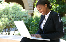 Woman outside on laptop