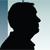 Silhouette of two men shaking hands
