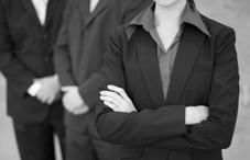 People in buisness suits with arms crossed