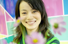 Woman smiling with pink daisies