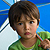 Child under umbrella.
