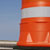 Orange road barrier and blue sky