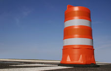 Orange road barrier and blue sky