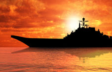 Aircraft carrier at sunset