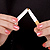 Woman's hands breaking a cigarette
