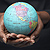 Woman's hands holding globe.