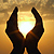 Silhouette of divine hands in sunset