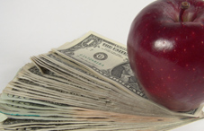 Apple on stack of money