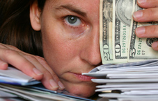 Woman holding bills and money