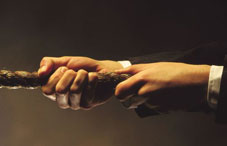 Business hands pulling rope
