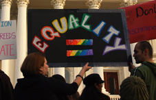 Women holding protest sign for gay rights