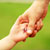 Parent holding child's hand
