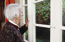 Elderly woman looking out the window