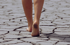 Woman walking barefoot in the desert