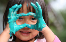Little girl with finger paint