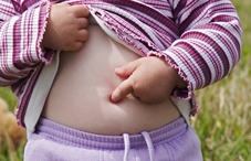 Child pointing to her belly