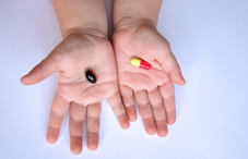 Child's hands with pills