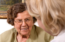 Doctor listening to elderly woman