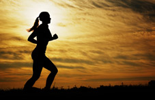 Woman running at sunset