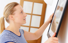 Woman hanging art