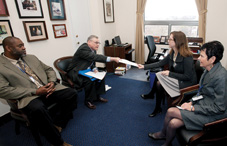 Members of the North Carolina Psychological Association share fact sheets with Laura Hooper, senior legislative aide for Rep. Melvin Watt (D-N.C.) highlighting the three key advocacy messages for the APA Practice Organization: Halting plummeting reimbursement rates for psychologists, including psychologists under Medicare's physician definition and making psychologists eligible for incentive payments in the HITECH Act. From left: Dr. Travis Colwell, Dr. Charles Cooper, Watt staffer Laura Hooper and Dr. Judith Patterson.