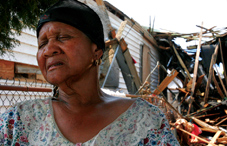 Katie Thornton of New Orleans sits outside her destroyed home in the wake of Hurricane Katrina. (credit: © Dan Anderson/epa/Corbis)