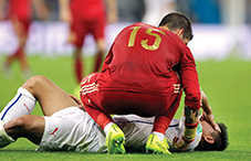 During the World Cup in June, Spain’s Sergio Ramos checks on Chile’s Eduardo Vargas after a collision during the Group B soccer match between the two countries (credit: © Natacha Pisarenko/AP/Corbis)
