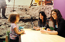 Dr. Lisa Feigenson, center, supervises and observes the research being conducted by postdoctoral student Melissa Kibbe with child participant Nora Hill at the Maryland Science Center, in Baltimore. (credit: Lloyd Wolf)