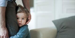 Parent comforting shy child.