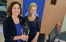 Dr. Michele Gregoire Gill, founder of Galileo School (left), and principal Michelle Nunez in Sanford, Florida, with their APA Golden Psi Award. (credit: Phelan Ebenhack/Silver Image Photo Agency)